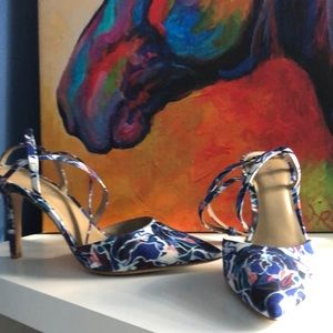 Strap high heel shoe.